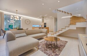 pexels photo 1571460 1571460 Contemporary living room with neutral tones, a sleek sofa, and elegant wooden staircase.